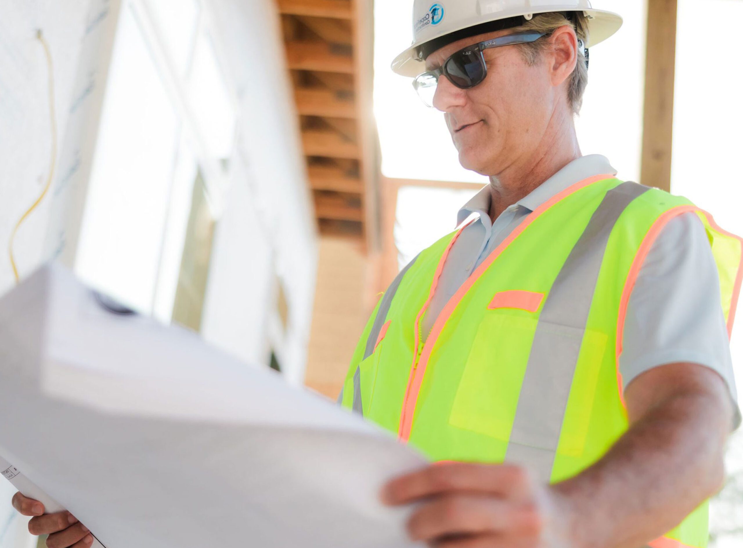 Construction worker reviewing a document on site