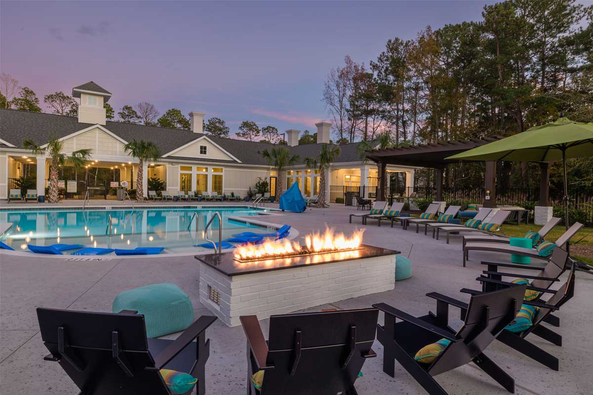 Riverwood Apartments exterior: pool + fire pit
