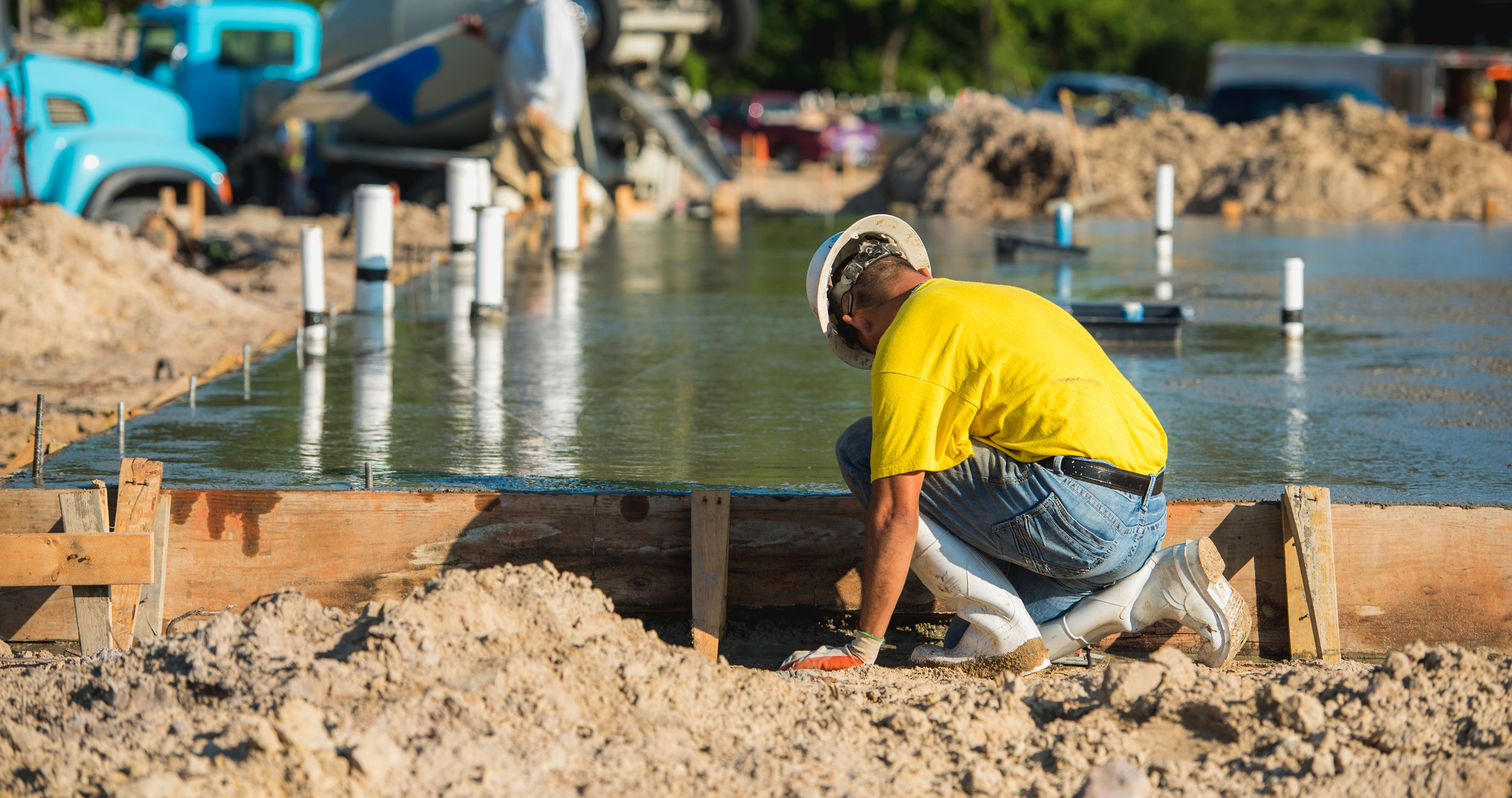 Construction worker laying cement