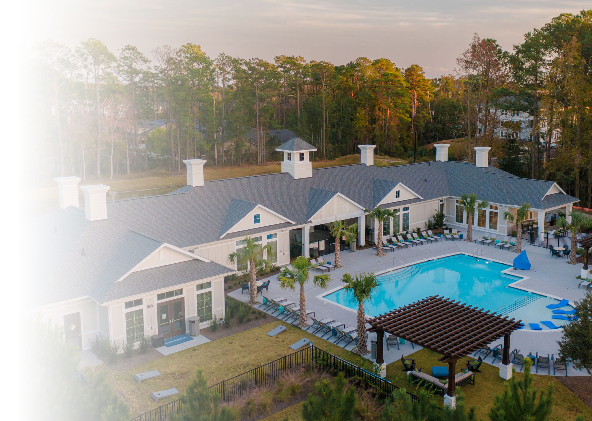 Aerial view of apartment complex pool + clubhouse